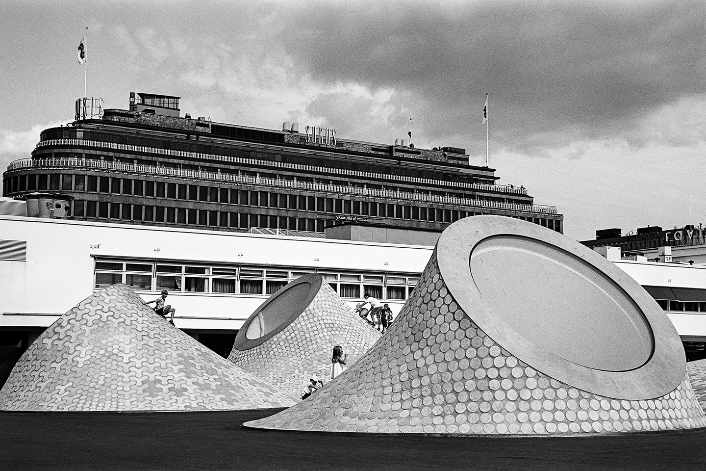 Black and white anlaog photograph of a woman eating a chocolate bar