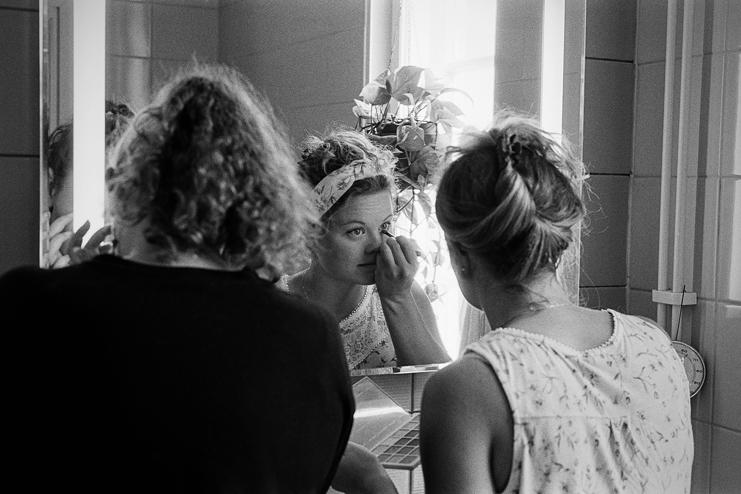 Black and white anlaog photograph of a woman eating a chocolate bar