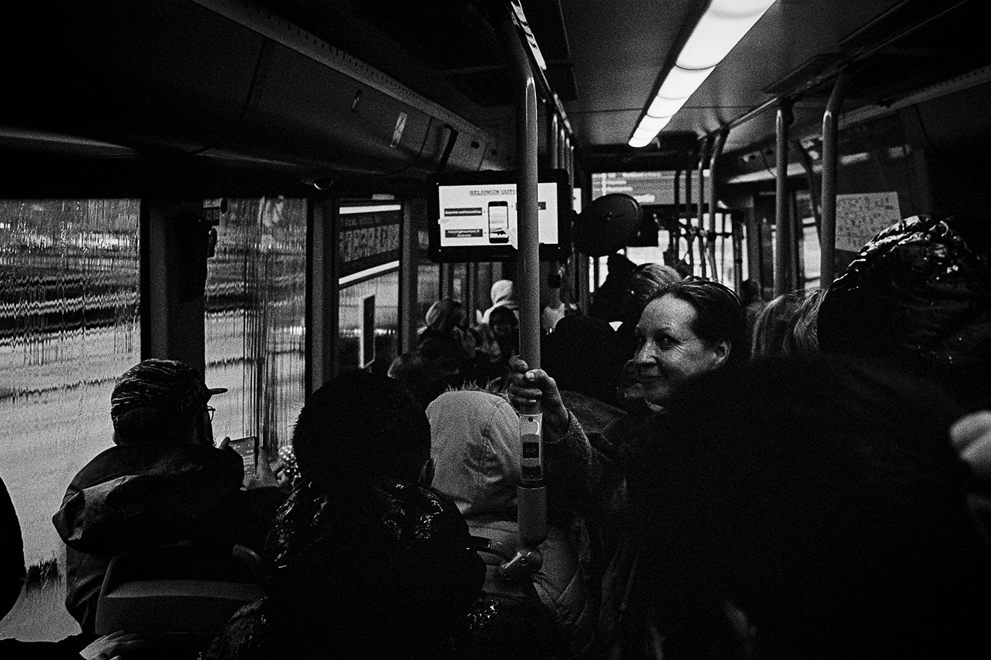 Black and white anlaog photograph of a woman eating a chocolate bar